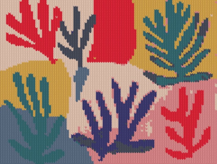 Cut-paper leaves in red, teal and indigo over blocks of mustard, pink and blue, knitted.